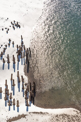 The importance of pier support;  a rotting pier in a winter landscape