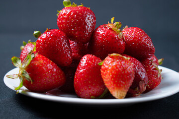 
fresh strawberries on white white plate