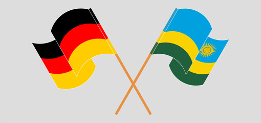 Crossed and waving flags of Germany and Rwanda