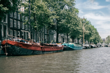 Fototapeta premium Amsterdam canal with historic ships and houses