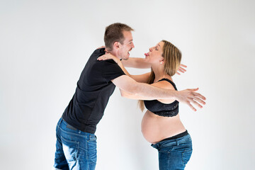 Portrait of young couple kiss and look happy about the pregnancy and the upcoming birth of their baby
