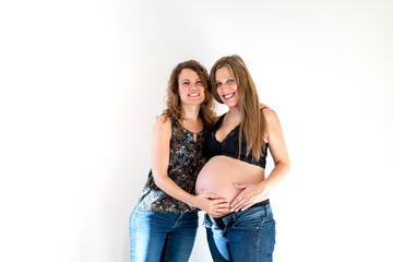 young couple or girl friends happy for the pregnancy of one of them and the future birth of their baby