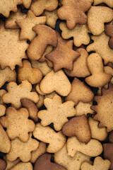 homemade curly gingerbread cookies lay in a continuous layer. view from above. art background or wallpaper for creative food design