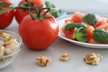 Fresh tomatoes, basil and walnuts as a healthy snack