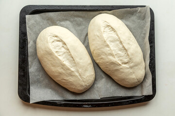 Yeast buns on a baking sheet