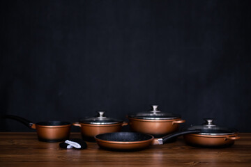 Set of grill pans on wooden table background