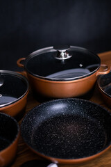 Set of grill pans on wooden table background