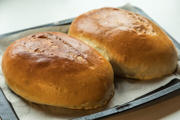 Yeast buns on a baking sheet