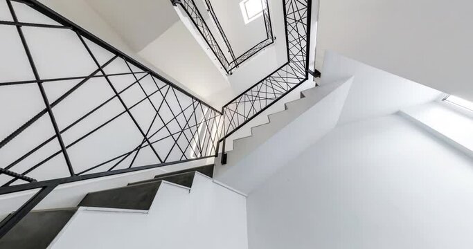 circular motion of spiral metal staircase in white empty interior hall of house, loop stair circular rotatio