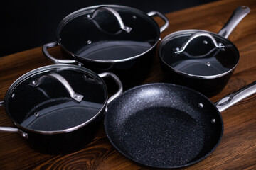 Set of grill pans on wooden table background