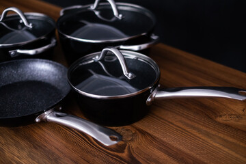 Set of grill pans on wooden table background