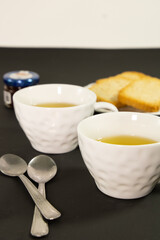 Tea cups, toastes and jam 