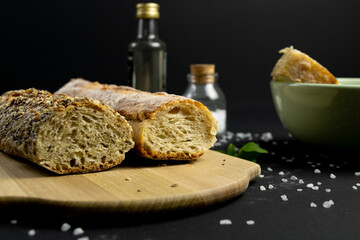 Rustic bread in a dark and wooden backgound 