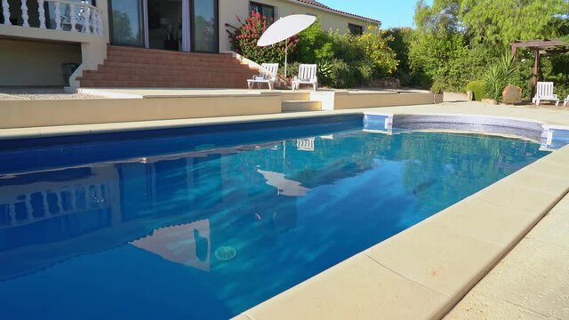 Great view of the pool with sun loungers for tourists and clear water. Luxury villa for tourists.