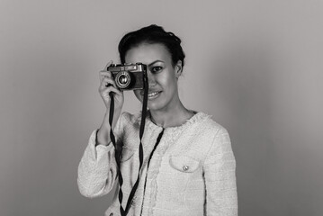 Pleasant african young woman making photos, studio shoot