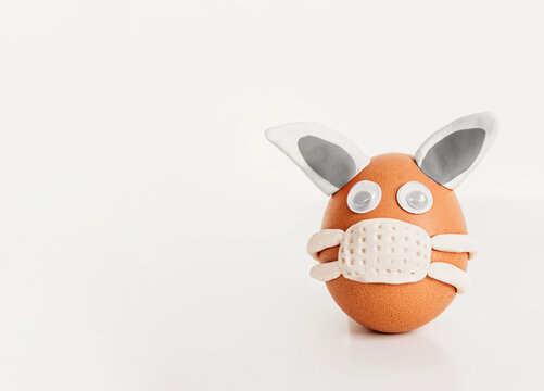 Easter egg bunny wearing mask.