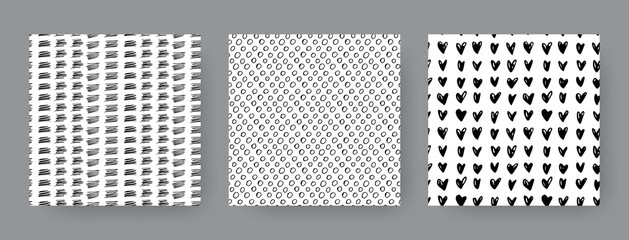 Set of hand-drawn seamless black and white patterns with dashes, circles and hearts. Vector backgrounds.