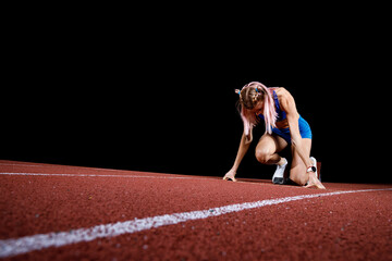 Female track runner on the starting block