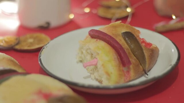 Rosca de reyes, traditional day in Mexico, feast day of the holy kings, rosca de reyes with doll, in red background.