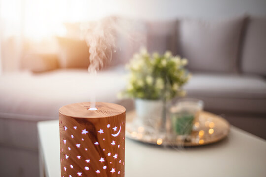 Essential oils diffusing at home in the morning light. Essential Oil Diffuser. Small air humidifier at home.  Aroma health essence, welness aromatherapy home spa fragrance tranquil theraphy