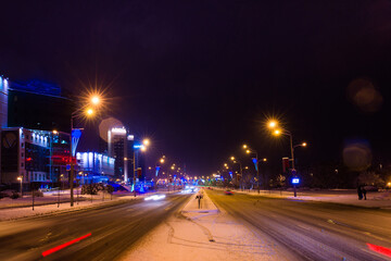 Fototapeta na wymiar Road in the winter night, city, cars, lights, speed.