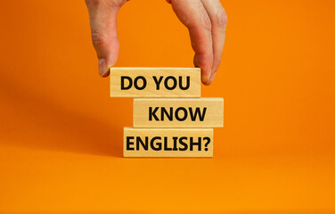 Do you know english symbol. Businessman hand. Wooden blocks with words 'Do you know english'....