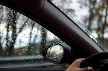 White woman hands driving a car