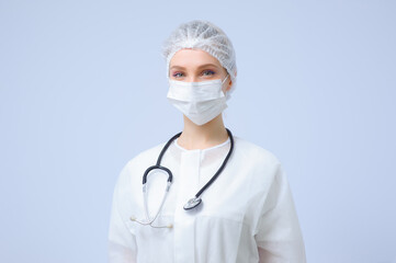 Portrait of a female doctor or nurse wearing medical cap and face mask