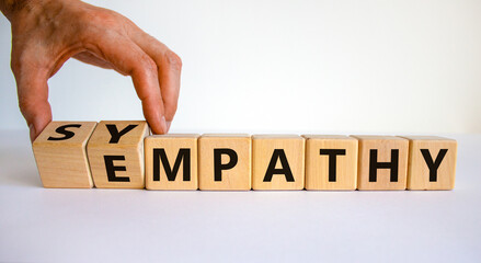 Sympathy or empathy symbol. Businessman turns wooden cubes and changes the word 'empathy' to...