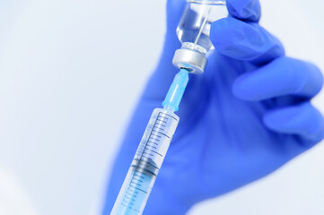 Doctor filling syringe with medication, closeup. Vaccination and immunization