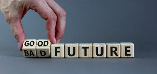 Good or bad future symbol. Businessman turns wooden cubes and changes words 'bad future' to 'good future'. Beautiful grey background, copy space. Business and bad or good future concept.