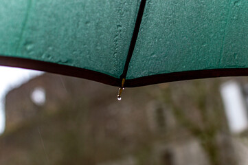 Dark green umbrella in rainy day