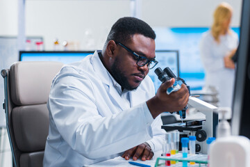 Professional team of scientists is working on a vaccine in a modern scientific research laboratory....