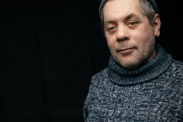 Close-up portrait of a smiling 60-year-old man with a wrinkled face. Positive and cheerful at any age.