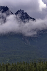 Clouds encircle mountains along Bow Valley Parkway in Alberta, Canada