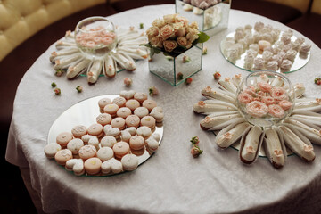 wedding sweet table filled with different desserts. festive banquet. wedding dessert. beautiful candy bar. large buffet.