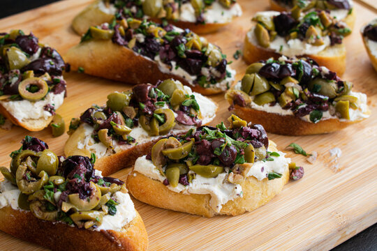 Herbed Olive Tapenade With Goat Cheese Bruschetta: Appetizer made of olive tapenade and goat cheese spread on toasted ciabatta bread