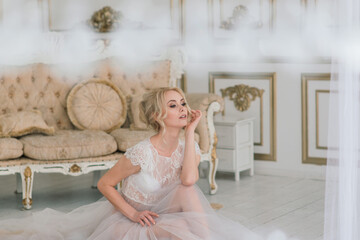 Morning of a beautiful young bride in a boudoir dress.