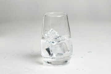 clean water is poured into a glass cup. ice in a glass.