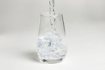 clean water is poured into a glass cup.