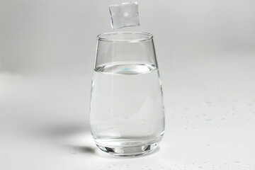 clean water is poured into a glass cup. ice in a glass.