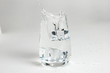 clean water is poured into a glass cup. ice in a glass.