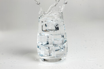 clean water is poured into a glass cup. ice in a glass.