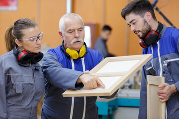 carpentry trainer giving lessons to apprentice