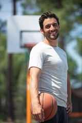 Poster full length portrait of a handsome basketball player standing © auremar