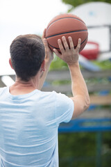 portrait of a basketball player taking a jump shot