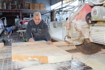 stoneworker taking mesurement