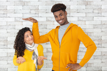 tall man measuring height of short woman