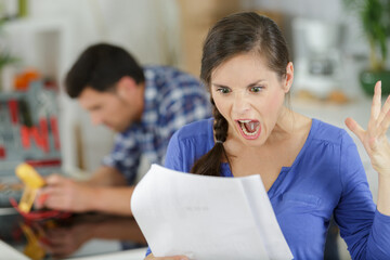 angry woman reading negative news in letter
