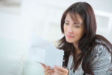 a woman is reading letter